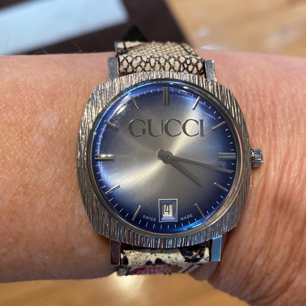Gucci watch with leather snake skin band.  excellent condition. No scratches.